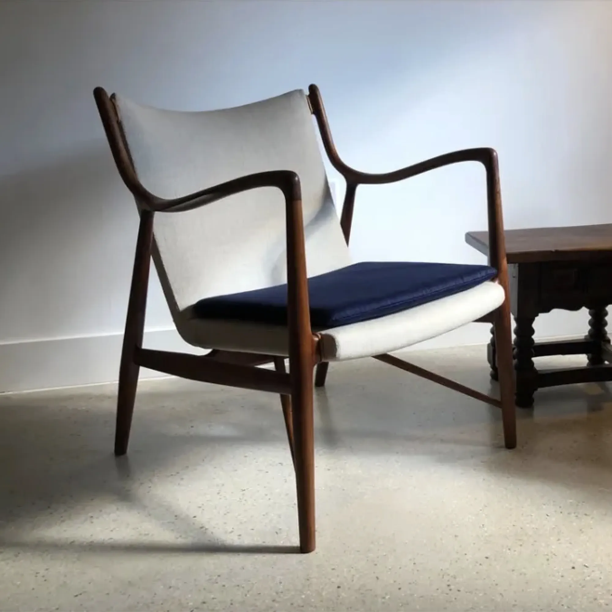 Finn Juhl 45 chair with oiled walnut frame and maharam silversmith dark leather upholstery